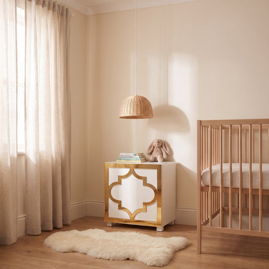Gold mirror Arabesque acrylic overlay on an IKEA Kallax cube in a warm nursery