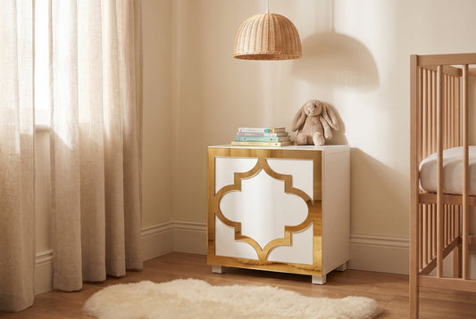 Gold mirror Arabesque acrylic overlay on an IKEA Kallax cube in a warm nursery