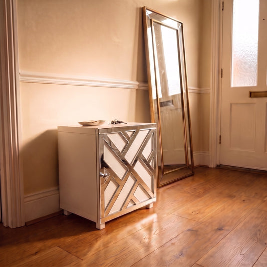 Mirrored chippendale criss cross acrylic overlay on a single IKEA Kallax cube with chrome knob in a warm hallway