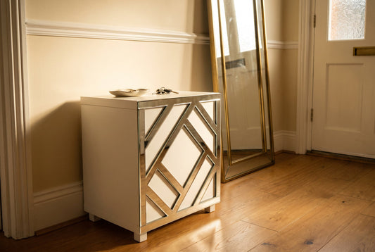 Silver mirror Criss Cross acrylic overlay on an IKEA Kallax cube in a warm hallway